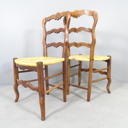 2579 - A set of six French oak rush-seated ladderback dining chairs.