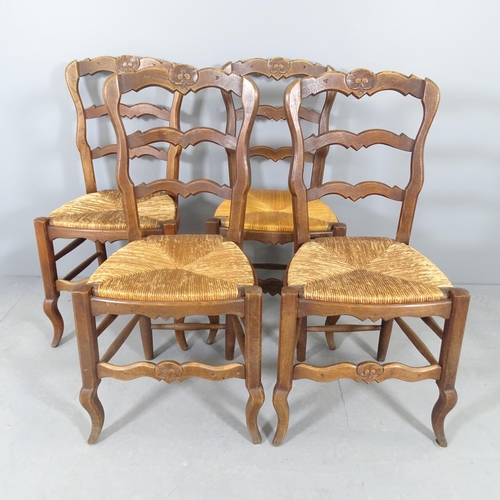 2580 - A set of four French oak rush-seated ladderback dining chairs. WITH THE OPTION TO PURCHASE THE FOLLO... 