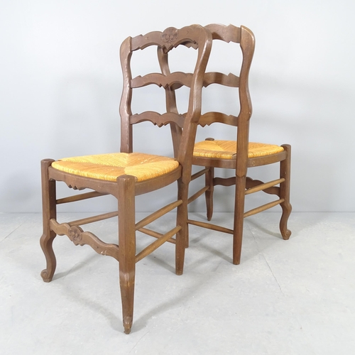 2581 - A set of four French oak rush-seated ladderback dining chairs.