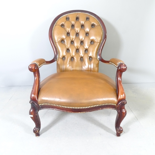 2584 - A reproduction mahogany and faux-leather upholstered low armchair.