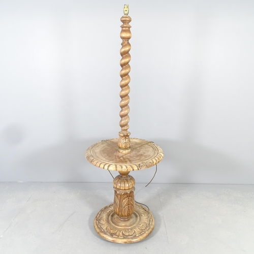 2587 - An early 20th century oak standard lamp, with barley-twist central column and carved baluster turned... 