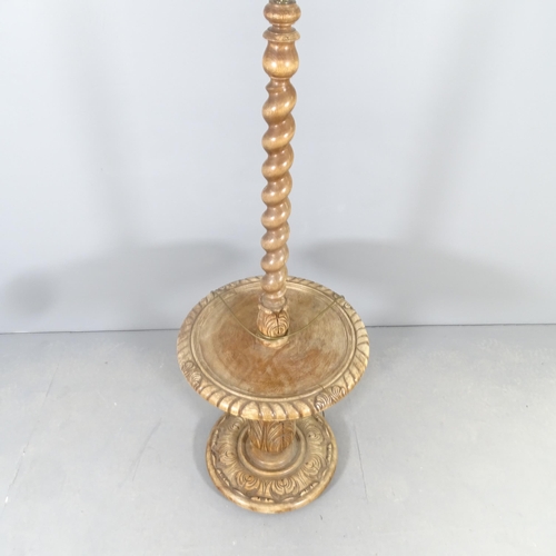 2587 - An early 20th century oak standard lamp, with barley-twist central column and carved baluster turned... 