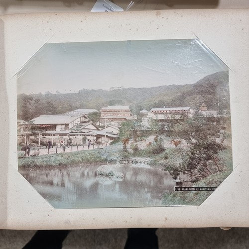 92 - An album of hand tinted original photographs depicting palaces and street scenes in Japan circa 1900... 