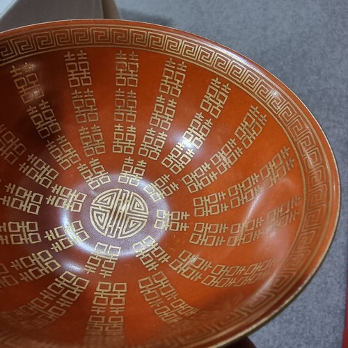 219 - A Chinese red glazed bowl with gilded decoration and 4 character mark to base, diameter 13cm