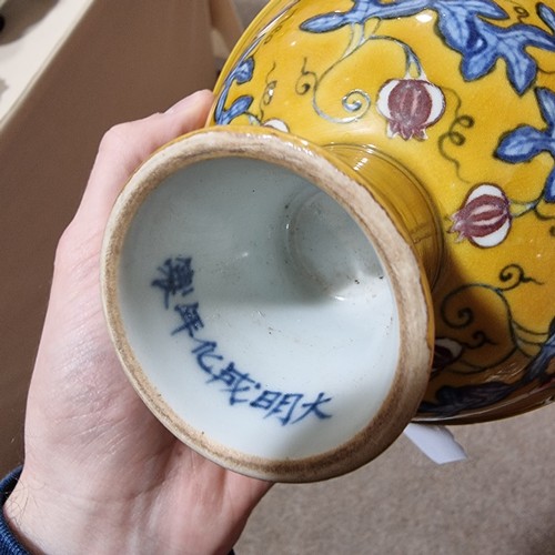 220 - A yellow Chinese stem bowl with blue under-glaze decoration, character marks inside base, height 10.... 