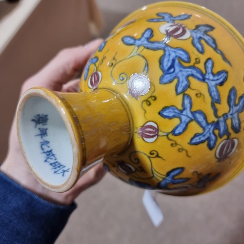 220 - A yellow Chinese stem bowl with blue under-glaze decoration, character marks inside base, height 10.... 