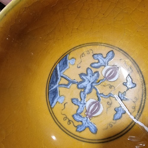 220 - A yellow Chinese stem bowl with blue under-glaze decoration, character marks inside base, height 10.... 