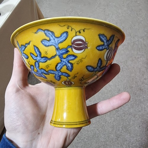 220 - A yellow Chinese stem bowl with blue under-glaze decoration, character marks inside base, height 10.... 