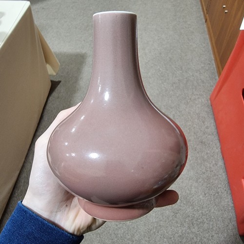 225 - A peach glaze narrow-neck vase, with character marks to base, height 19cm