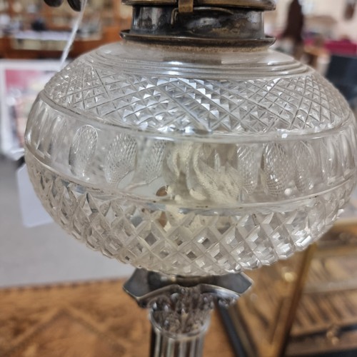 208 - A late 19th century silver plated Corinthian column oil lamp with cut-glass well, with later shade a... 