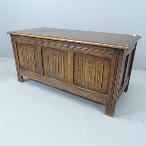 2132 - An oak coffer with linenfold carved panels. 106x51x46cm.