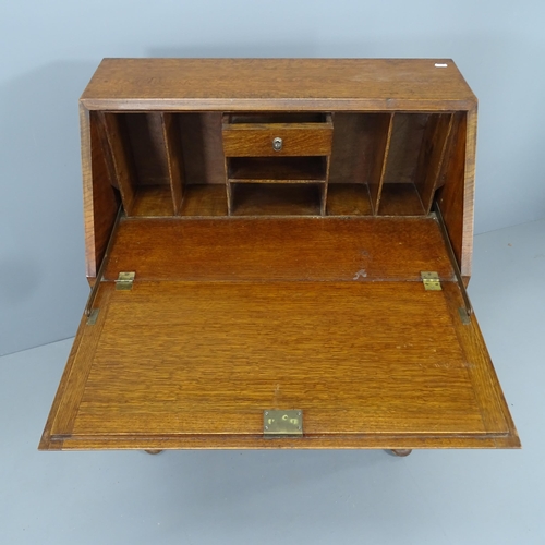 2135 - A 1920s oak bureau, the fall-front revealing a fitted interior with two long drawers below. 82x99x45... 