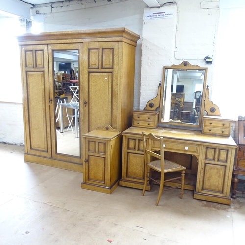 2137 - A 1930s maple bedroom suite comprising a three-door wardrobe in five sections, 192x310x60cm, a mirro... 