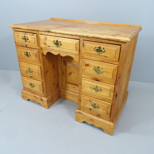 2138 - A modern pine kneehole desk, with nine drawers and recessed cupboard. Overall 101x78x56cm, kneehole ... 