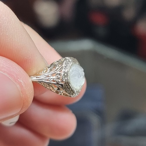 1217 - An Art Deco moonstone 'man in the moon' ring, unmarked gold settings with octagonal head and pierced... 