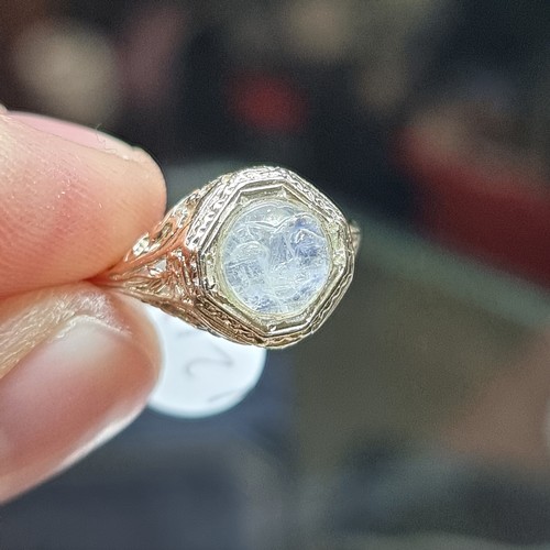 1217 - An Art Deco moonstone 'man in the moon' ring, unmarked gold settings with octagonal head and pierced... 