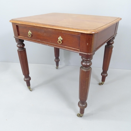 2158 - A Victorian writing table, with single frieze drawer and raised on turned legs with brass casters. 7... 