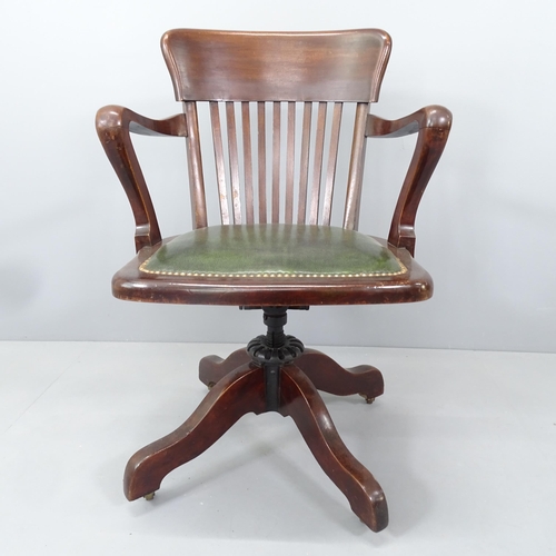 2159 - An Antique oak and studded leather upholstered swivel Captains desk chair.