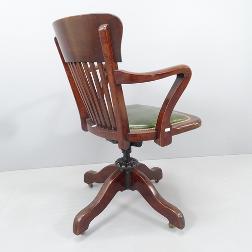 2159 - An Antique oak and studded leather upholstered swivel Captains desk chair.