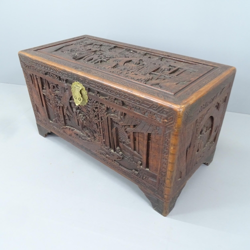 2162 - A Chinese camphorwood trunk with all-over carved decoration and tray fitted interior. 102x86x51cm