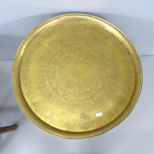 2163 - Two similar eastern brass tray-top tables on folding base. Largest 60x59cm.