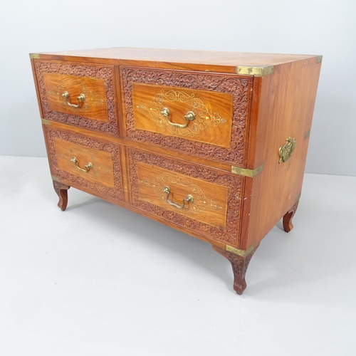 2166 - A Chinese camphorwood military style chest of four drawers, with brass mounts and carved decoration.... 