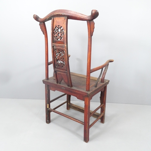 2167 - An antique elm Chinese emperor's throne chair, with carved and pierced decoration. Overall 68x118x52... 