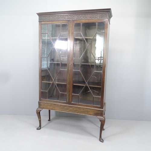 2172 - A Chippendale style mahogany bookcase on stand, with applied carved decoration, two lattice glazed d... 