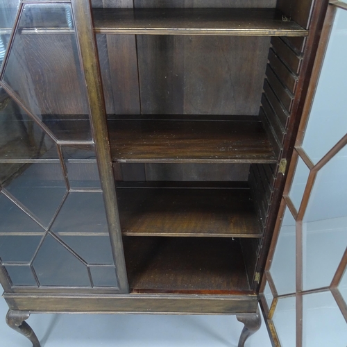 2172 - A Chippendale style mahogany bookcase on stand, with applied carved decoration, two lattice glazed d... 