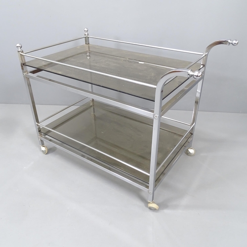 2258 - A mid-century chrome and smoked-glass two-tier drinks trolley by Merrow Associates. 88x68x49cm.