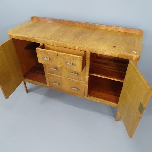 2270 - An Art Deco oak sideboard by Heal's of London with three central drawers, two side cupboards, and in... 