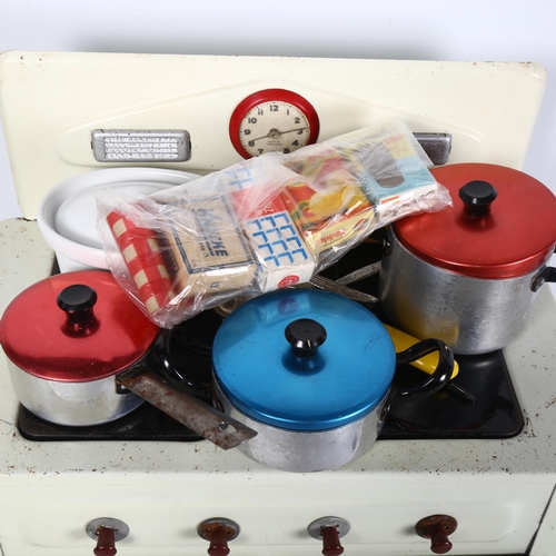 121 - AMERSHAM TOYS - a Vintage tinplate toy cooker and associated accessories