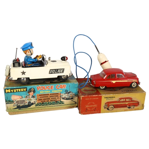 146 - A tinplate battery powered Mystery Police car, in original box, and a Wells Brimtoy Vauxhall electri... 