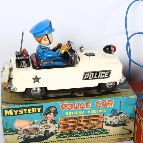 146 - A tinplate battery powered Mystery Police car, in original box, and a Wells Brimtoy Vauxhall electri... 