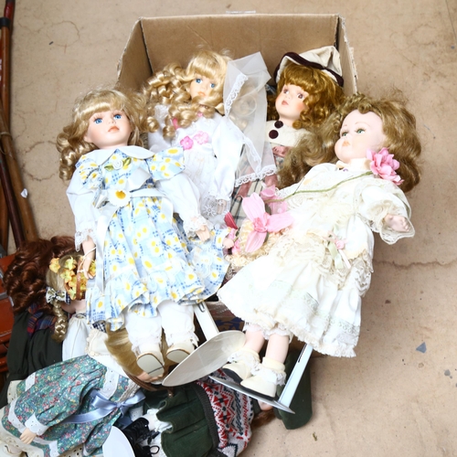 212 - A large quantity of porcelain dolls, unboxed, some on display stands