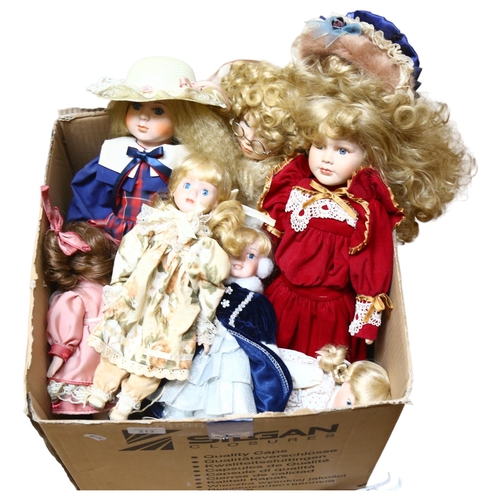 213 - A large quantity of porcelain dolls, unboxed, some on display stands