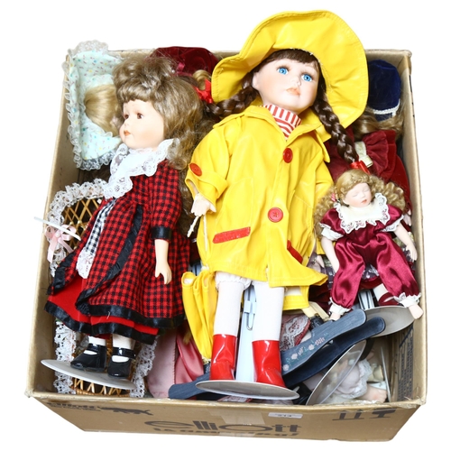 214 - A large quantity of porcelain dolls, unboxed, some on display stands