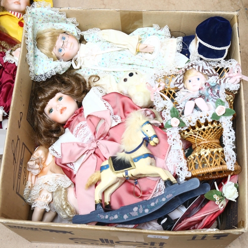 214 - A large quantity of porcelain dolls, unboxed, some on display stands