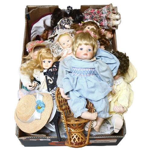 215 - A large quantity of porcelain dolls, unboxed, some on display stands