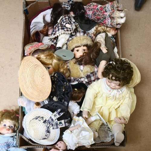 215 - A large quantity of porcelain dolls, unboxed, some on display stands