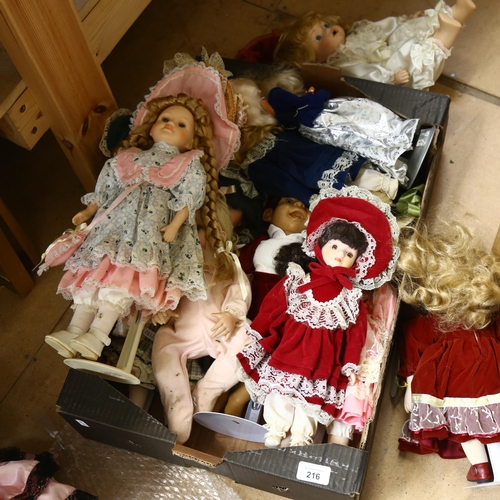 216 - A large quantity of porcelain dolls, unboxed, some on display stands