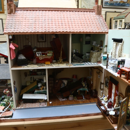 224 - A 1940s style doll's house and garden, 2 floors with fitted interior and associated garden scene, in... 