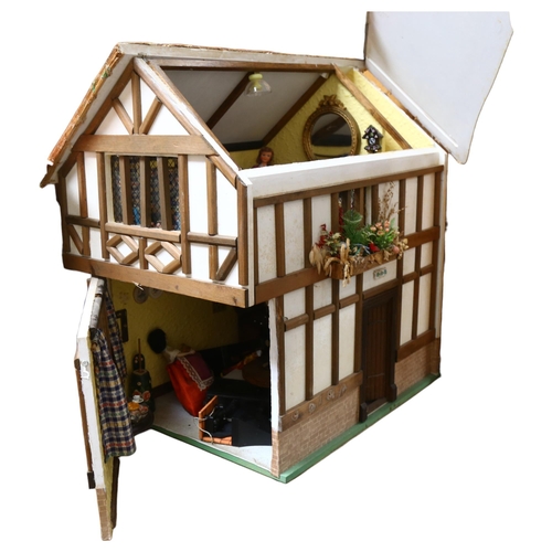 227 - A Tudor style doll's house, over 2 floors, with partially removeable roof, fitted interior, includes... 