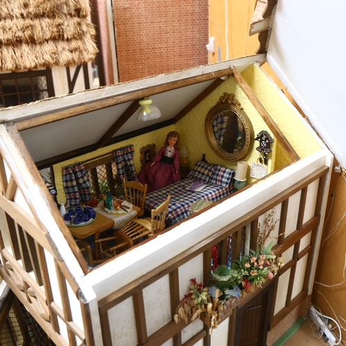 227 - A Tudor style doll's house, over 2 floors, with partially removeable roof, fitted interior, includes... 