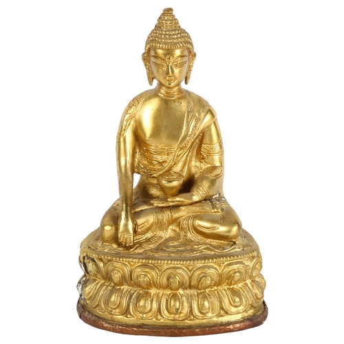 260 - A gilded spelter temple Buddha, with pressed copper base, height 21cm