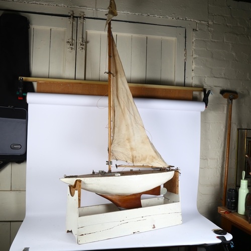 264 - A large scratch-build pond yacht and stand, length 93cm