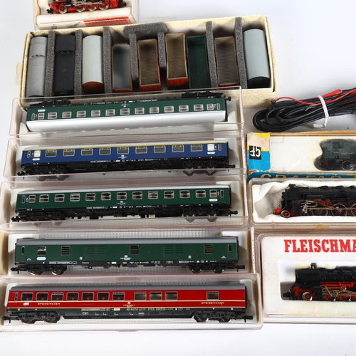 27 - A quantity of N gauge locomotives, coaches and goods wagons, including Fleischmann, Arnold, Grafar R... 