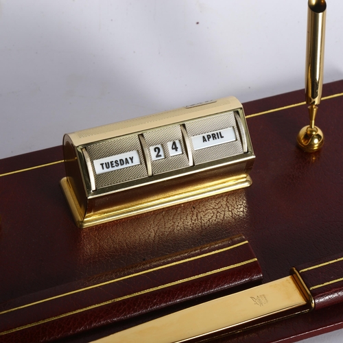 276 - ASPREY'S OF LONDON - a red leather desk-top perpetual calendar and pen holder, with letter opener, w... 