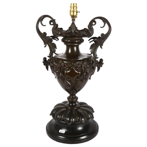 300 - A large 19th Century patinated bronze 2-handled urn, with later conversion to a table lamp, on a lat... 