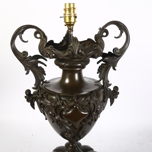 300 - A large 19th Century patinated bronze 2-handled urn, with later conversion to a table lamp, on a lat... 